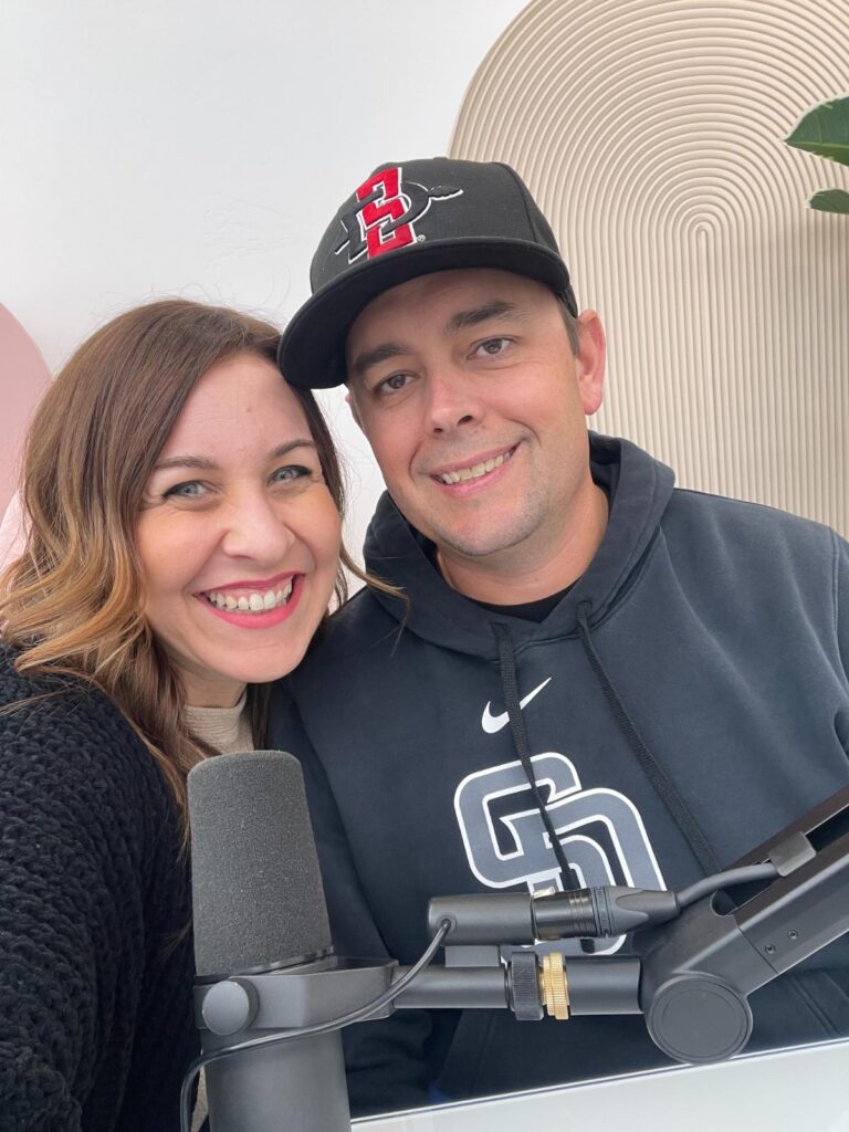Jeremy and Becky with a podcast microphone in front of them